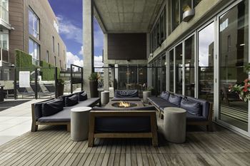 a patio with couches and a fire pit in the middle of a building at The Shay, District of Columbia